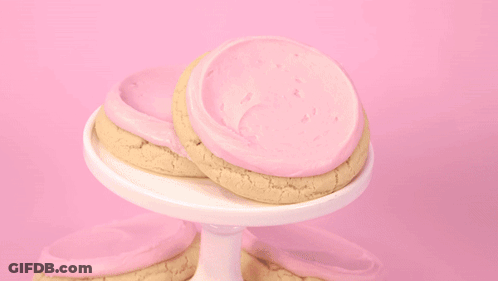 Person Scooping Ice Cream Into Cookie GIF