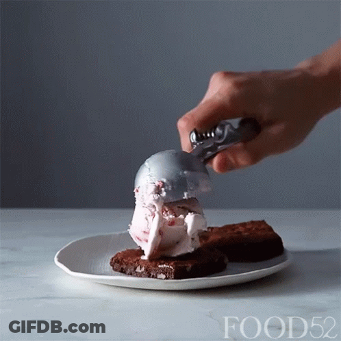 Person Scooping Ice Cream Onto Brownies GIF