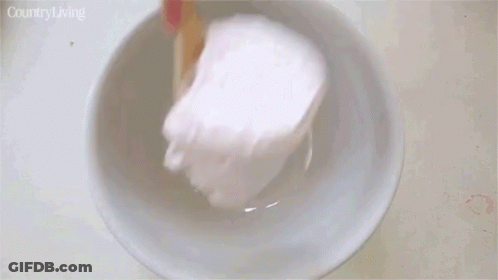 Person Scooping Strawberry Ice Cream Into Bowl GIF