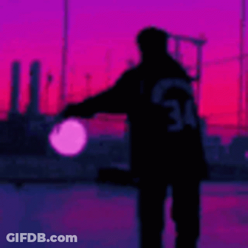 Person Silhouette Holding Light At Sunset GIF