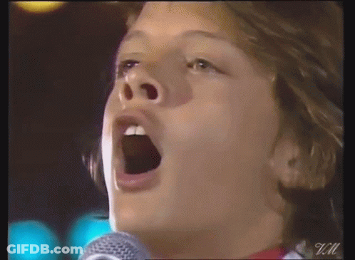 Person Singing Into Microphone GIF