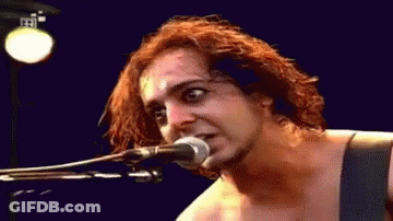 Person Singing Into Microphone Blue Background GIF