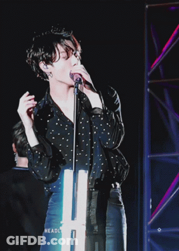 Person Singing Into Microphone With Headl GIF
