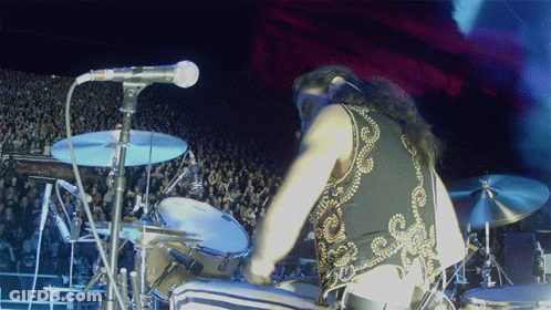 Person Singing Into Microphone With Star Shirt GIF