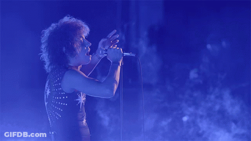 Person Singing Into Microphone With Star Shirt GIF