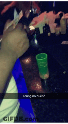 Person Sitting At Bar With Green Shot Glass GIF