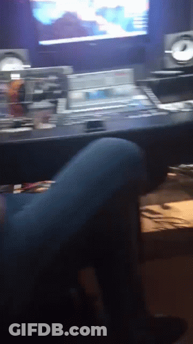 Person Sitting At Desk In Front Of TV GIF