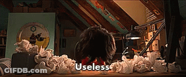 Person Sitting At Desk With Crumpled Paper And Useless GIF