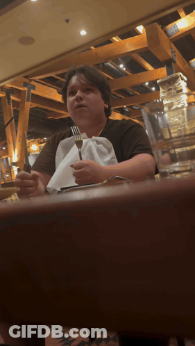 Person Sitting At Table With Fork And Knife GIF