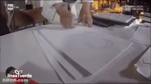 Person Sitting At Table With Papers And Microphone GIF