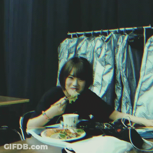 Person Sitting At Table With Plate Of Food GIF