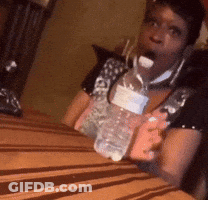 Person Sitting At Table With Water Bottle GIF