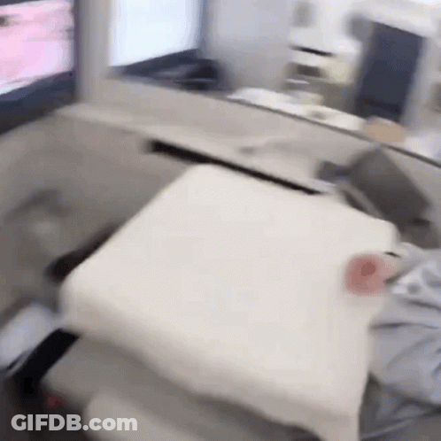 Person Sitting In Chair With White Pillow GIF