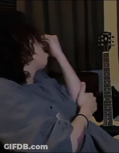 Person Sitting In Front Of Gibson Guitar GIF
