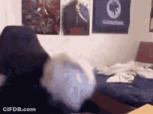 Person Sitting On Bed With Gladiator Poster GIF