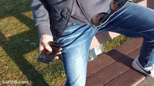 Person Sitting On Bench Holding Phone And Sunglasses GIF