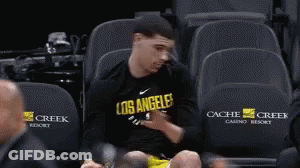 Person Sitting On Blue Ice Slope GIF
