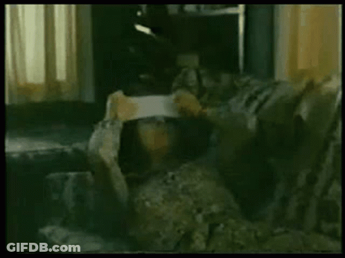 Person Sitting On Couch Holding Paper GIF