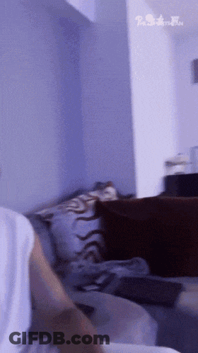Person Sitting On Couch With The Simpson Family Sign GIF