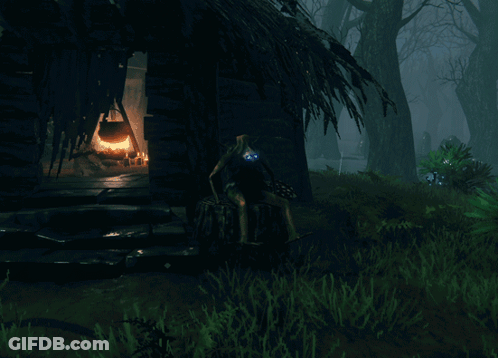 Person Sitting On Stump In Front Of Hut GIF