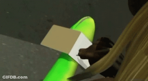 Person Sitting With Green Balloon And Cardboard Box GIF