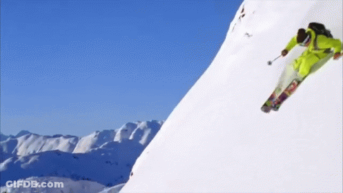 Person Skiing Down Snowy Mountain GIF