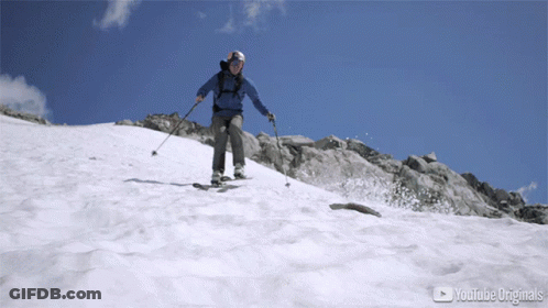Person Skiing Down Snowy Mountain With YouTube Originals Logo GIF