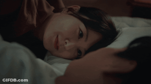 Person Sleeping In Bedroom With Desk And Lamp GIF