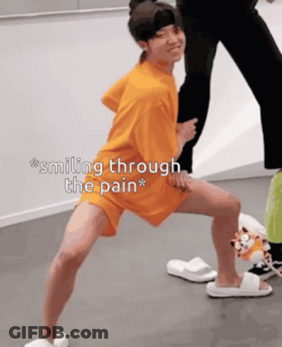 Person Smiling Through Pain Standing On One Leg GIF