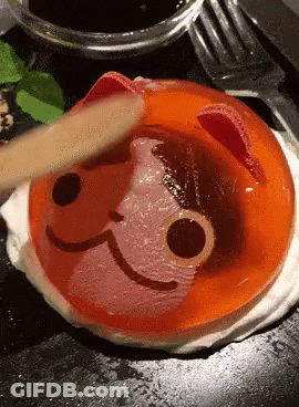 Person Spreading Cat Face Jelly With Wooden Spoon GIF