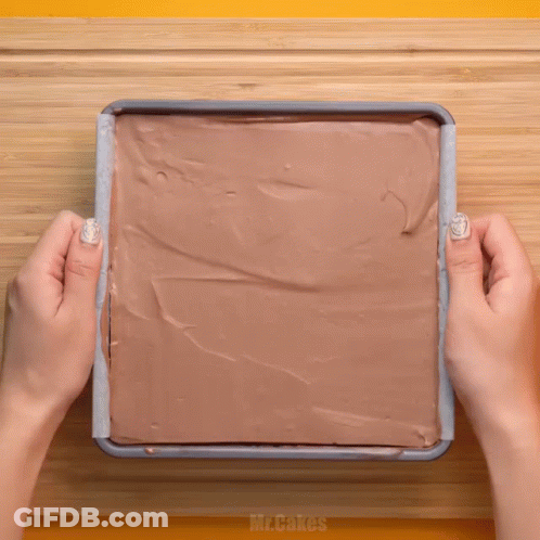 Person Spreading Chocolate Frosting GIF