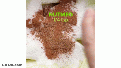 Person Spreading Nutmeg 1/4 Tsp On Cake GIF
