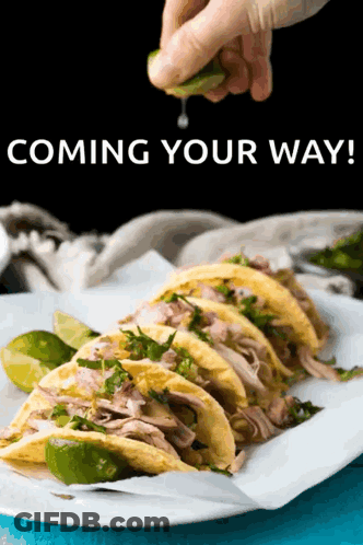 Person Squeezing Lime Over Tacos GIF