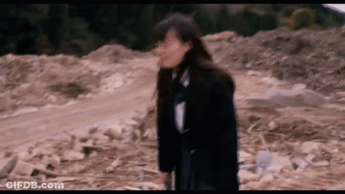 Person Squeezing Orange In Fist City Background Pause (N) GIF