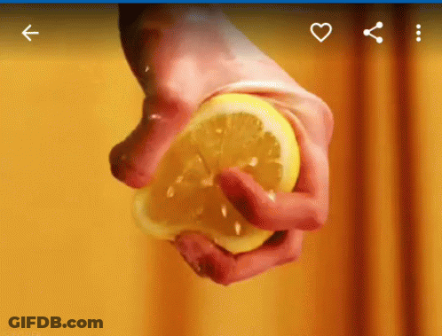 Person Squeezing Slice Of Lemon GIF