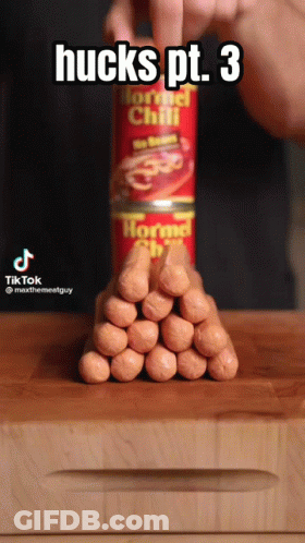 Person Stacking Hot Dogs On Horned Chili Can GIF