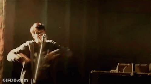 Person Standing Arms Outstretched In Dark Room GIF