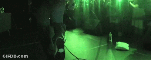 Person Standing At Microphone In Dark Room GIF