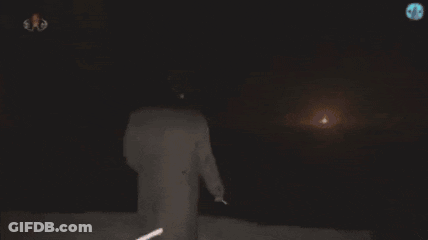 Person Standing Before Glowing Skull GIF