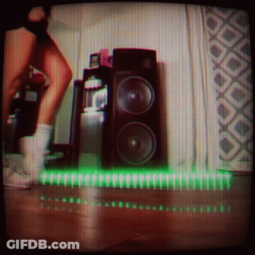 Person Standing Before Speaker With Green Light GIF