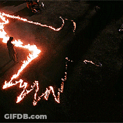 Person Standing In Circle Of Flames Saying Win GIF
