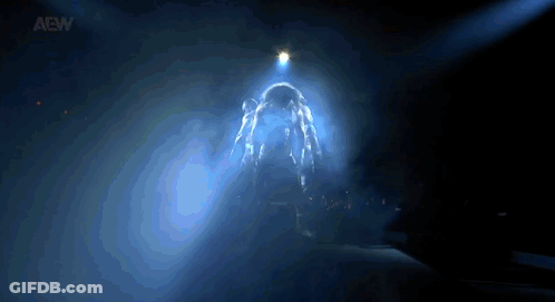 Person Standing In Dark Room With Light Shining GIF