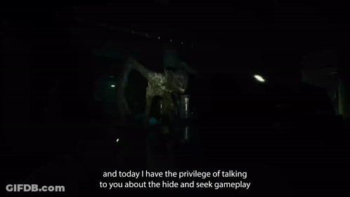 Person Standing In Dark Room With Monster GIF