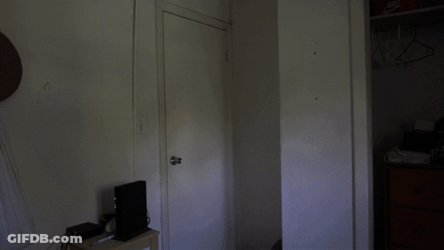 Person Standing In Dark Room With Nike Logo GIF