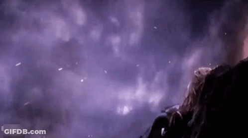 Person Standing In Dark Room With Purple Smoke GIF
