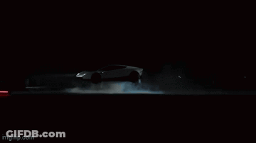 Person Standing In Dark Room With Smoke From Mouth GIF