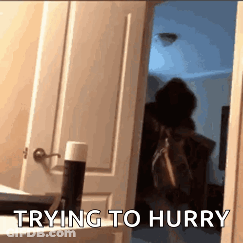 Person Standing In Doorway Trying To Hurry GIF