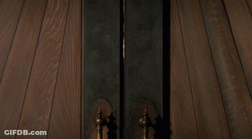 Person Standing In Doorway With Light GIF