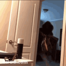 Person Standing In Doorway With Purse GIF