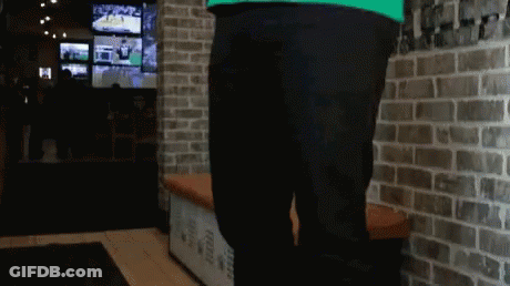 Person Standing In Front Of Brick Wall GIF